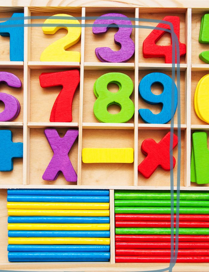 Box of wooden numbers and math manipulatives for elementary